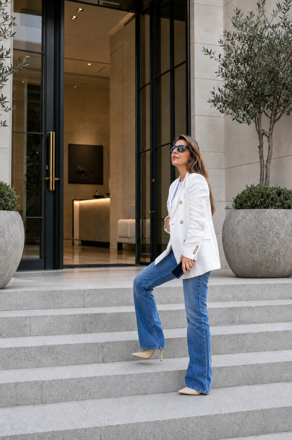 Melanie Balasopulos photographed on a staircase in natural light